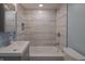 Updated bathroom with a gray and white tile shower/tub combo at 3730 Prospect St, Indianapolis, IN 46203