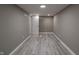 Finished basement room with gray walls and vinyl plank flooring at 3730 Prospect St, Indianapolis, IN 46203