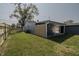 Spacious backyard with a covered patio and a wooden privacy fence at 3730 Prospect St, Indianapolis, IN 46203