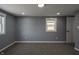 Gray-walled bedroom with new carpet and a window offering natural light at 3730 Prospect St, Indianapolis, IN 46203