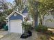 Charming blue two-story home with a white garage door and landscaping at 3213 Oceanline E Dr, Indianapolis, IN 46214
