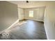 Sunlit living room with gray vinyl flooring and neutral walls at 6733 S Cross St, Pendleton, IN 46064
