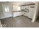 Modern kitchen with white cabinets and vinyl flooring at 6733 S Cross St, Pendleton, IN 46064