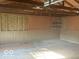 Empty garage with wood paneling and shelving at 6733 S Cross St, Pendleton, IN 46064