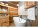 Rustic bathroom with wood walls,freestanding tub, and updated vanity at 7393 N Thunder Creek Ridge Rd, Morgantown, IN 46160