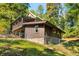 Log cabin home with a brown addition and a green metal roof at 7393 N Thunder Creek Ridge Rd, Morgantown, IN 46160