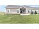The backyard features a concrete patio, grassy area, and some shrubs at 6210 Fairview Dr, McCordsville, IN 46055