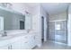 Modern bathroom with double vanity, glass shower, and tile flooring at 6210 Fairview Dr, McCordsville, IN 46055