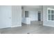 Open concept dining area adjacent to the kitchen with white cabinetry and light gray flooring at 6210 Fairview Dr, McCordsville, IN 46055