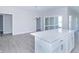 Kitchen island and dining space with sliding glass doors to the outdoor patio area at 6210 Fairview Dr, McCordsville, IN 46055