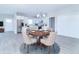 Virtually staged dining area with round table, and view of the kitchen at 6210 Fairview Dr, McCordsville, IN 46055
