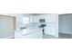 Contemporary kitchen with white cabinets, stainless appliances, a center island, and light gray flooring at 6210 Fairview Dr, McCordsville, IN 46055