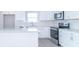 Bright, modern kitchen featuring white shaker cabinets, stainless steel appliances, and a large island at 6210 Fairview Dr, McCordsville, IN 46055