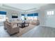 Virtually staged living room with comfortable seating, a coffee table, and decorative rug at 6210 Fairview Dr, McCordsville, IN 46055