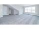 Spacious, naturally lit loft or bonus room with gray carpet and white walls at 6210 Fairview Dr, McCordsville, IN 46055