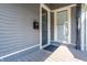 Side entrance porch with gray wood siding and mailbox at 1715 Alabama St, Indianapolis, IN 46202