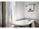 Elegant bathroom featuring a clawfoot tub and window at 1715 Alabama St, Indianapolis, IN 46202