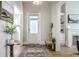 Bright entryway with hardwood floors, decorative rug, and coat rack at 1715 Alabama St, Indianapolis, IN 46202