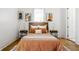 Small bedroom with orange bedding and hardwood floors at 1715 Alabama St, Indianapolis, IN 46202