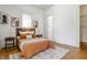 Bedroom with orange bedding and hardwood floors at 1715 Alabama St, Indianapolis, IN 46202
