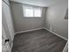 Bright bedroom with gray walls and wood-look flooring at 4050 Byram Ave, Indianapolis, IN 46208