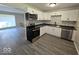 Modern kitchen with white cabinets, gray countertops, and stainless steel appliances at 4050 Byram Ave, Indianapolis, IN 46208