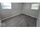Well-lit bedroom featuring gray walls and wood-look floors at 4050 Byram Ave, Indianapolis, IN 46208