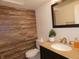 Small bathroom with wood-look wall and granite countertop at 7419 Sylvan Ridge Rd, Indianapolis, IN 46240