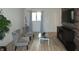 Living room features hardwood floors, two armchairs, and a TV at 7419 Sylvan Ridge Rd, Indianapolis, IN 46240
