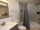 Basement bathroom with tub, shower, and gray tile at 7419 Sylvan Ridge Rd, Indianapolis, IN 46240