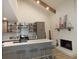 Modern kitchen with island, fireplace, and open shelving at 7419 Sylvan Ridge Rd, Indianapolis, IN 46240