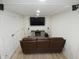 Finished basement with home theater setup and leather couch at 7419 Sylvan Ridge Rd, Indianapolis, IN 46240