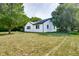 Side view of the white brick house at 8480 S Honeycreek Rd, Muncie, IN 47302