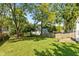 Spacious backyard with mature trees and wooden fence at 5648 N Keystone Ave, Indianapolis, IN 46220