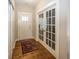 Bright entryway with hardwood floors, featuring a coat closet and French doors at 1569 Tupelo Dr, Greenfield, IN 46140