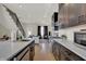 Modern kitchen with dark cabinetry, quartz countertops, and stainless steel appliances at 417 E Morris St, Indianapolis, IN 46225
