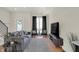 Modern living room features hardwood floors, a gray sofa, and a large TV at 417 E Morris St, Indianapolis, IN 46225