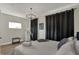 Bedroom with a queen bed, hardwood floors, and a large window at 417 E Morris St, Indianapolis, IN 46225