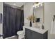 Contemporary bathroom with gray vanity, white sink, and gold accents at 417 E Morris St, Indianapolis, IN 46225