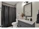 Modern bathroom with gray vanity, white sink, and black accents at 417 E Morris St, Indianapolis, IN 46225