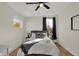Cozy bedroom with a queen bed, ceiling fan, and large window at 417 E Morris St, Indianapolis, IN 46225