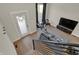 Upstairs living area with hardwood floors, gray sofa, and stairs at 417 E Morris St, Indianapolis, IN 46225