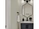 Small bathroom with hexagon mirror and dark vanity at 417 E Morris St, Indianapolis, IN 46225