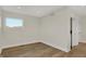 Simple bedroom with hardwood floors and a window with natural light at 417 E Morris St, Indianapolis, IN 46225