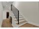 Modern staircase with light wood steps and black metal railing at 417 E Morris St, Indianapolis, IN 46225