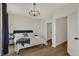 Bright bedroom with a queen bed, wood floors, and plenty of natural light at 417 E Morris St, Indianapolis, IN 46225