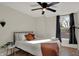 Bright bedroom with a full bed, ceiling fan, and hardwood floors at 417 E Morris St, Indianapolis, IN 46225