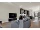Open concept living room with gray sofa and kitchen view at 417 E Morris St, Indianapolis, IN 46225