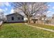 Large backyard with a tree and a wooden fence at 385 S Arlington Ave, Indianapolis, IN 46219