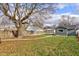 Backyard view showcasing a detached garage and a tree at 385 S Arlington Ave, Indianapolis, IN 46219